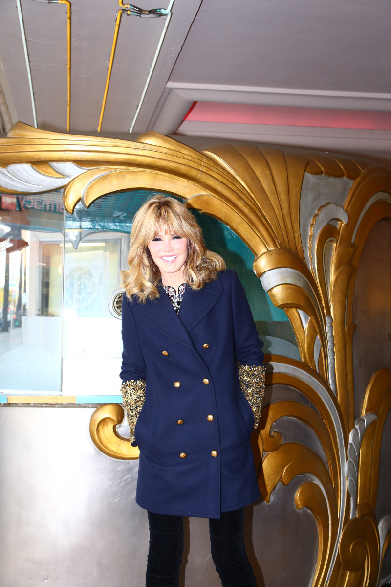 Laura Dunn wears the new gold sequin cuff embellished Michael Kors Collection coat